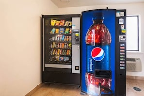 A vending machine with a Pepsi logo and a snack vending machine next to it. - 1 Queen Bed | Non-Smoking (Greensboro)