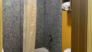 A bathroom with a bathtub, a shower curtain, and a toilet. - 2 Queen Beds|Smoking,Micfridge (Morrilton)