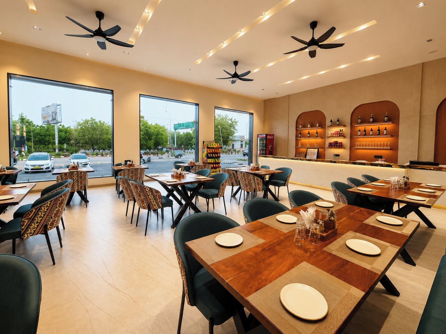 A restaurant interior with multiple dining tables, chairs, ceiling fans, and a wine display.