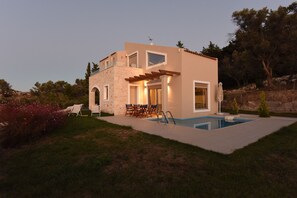 A two-story house with a stone facade, a swimming pool, and outdoor seating. - Mon Emvasia Margarites Villa B (Mylopotamos)