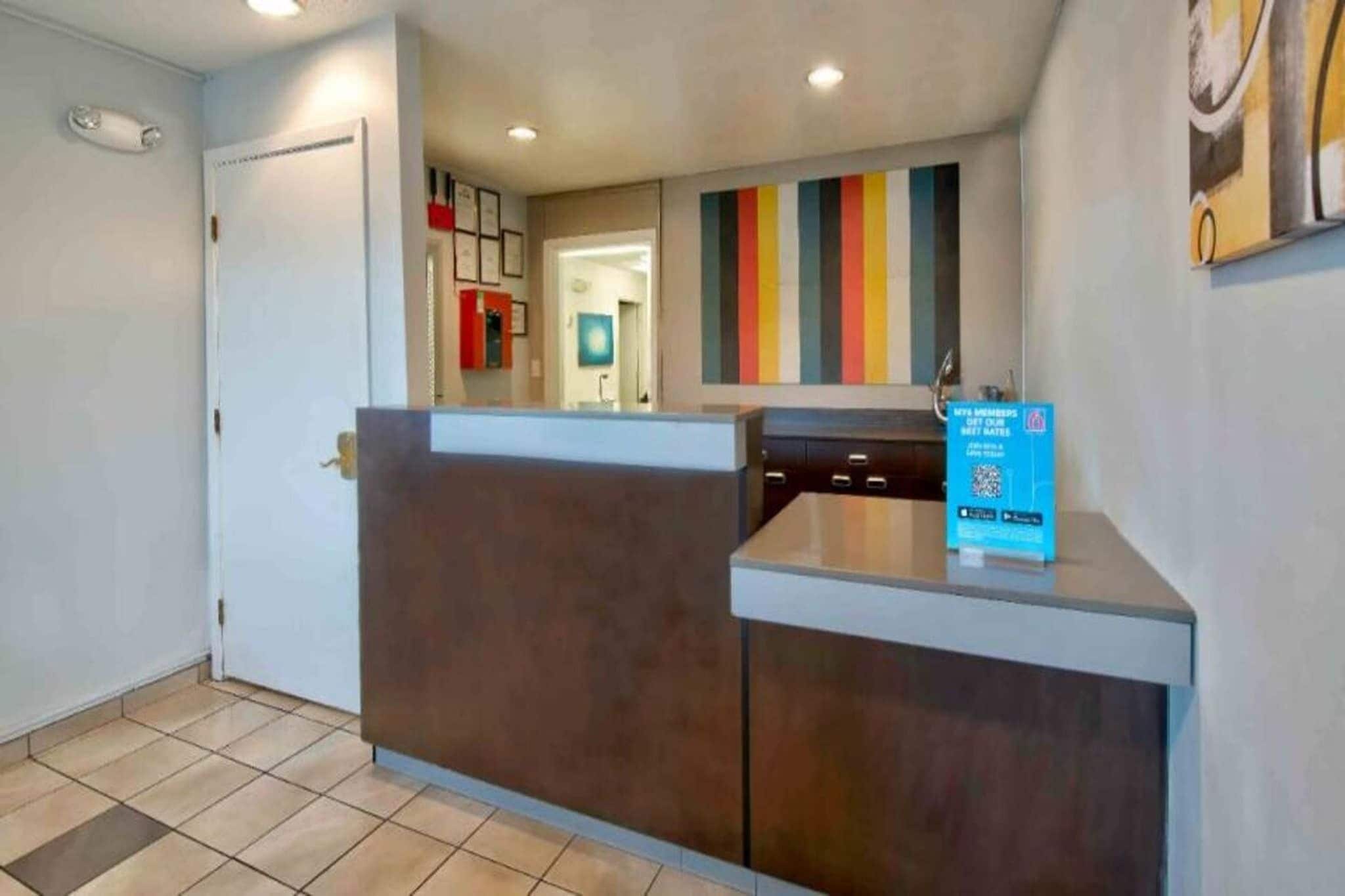 A reception area with a counter, a door, and a wall with a vertical stripe pattern.