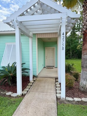 A covered porch with a concrete path leading to a door marked '4275B'. - 3-bedroom pet-friendly condo in Orange Beach, sleeps 8 (Orange Beach)