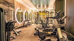 A gym with cardio machines, weightlifting equipment, and mirrors on the walls. - Çenger Blue Collection All Inclusive (Manavgat)
