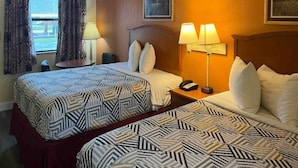 A hotel room with two beds, a nightstand with a lamp, a telephone, and a window with curtains. - 2 Queen Beds|Non-Smoking,Micfridge (Morrilton)
