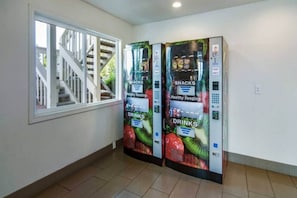 A hallway with two vending machines labeled 'Healthy Vending' for snacks and drinks.