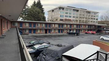 A multi-story parking garage with several cars parked.