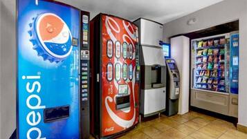 Vending machines with Pepsi and Coca-Cola branding, an ATM, and a snack vending machine.
