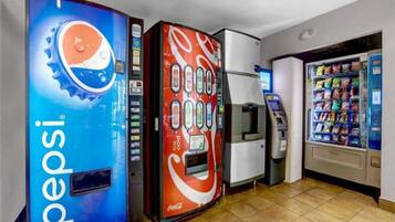 Vending machines with Pepsi and Coca-Cola branding, an ATM, and a snack vending machine.