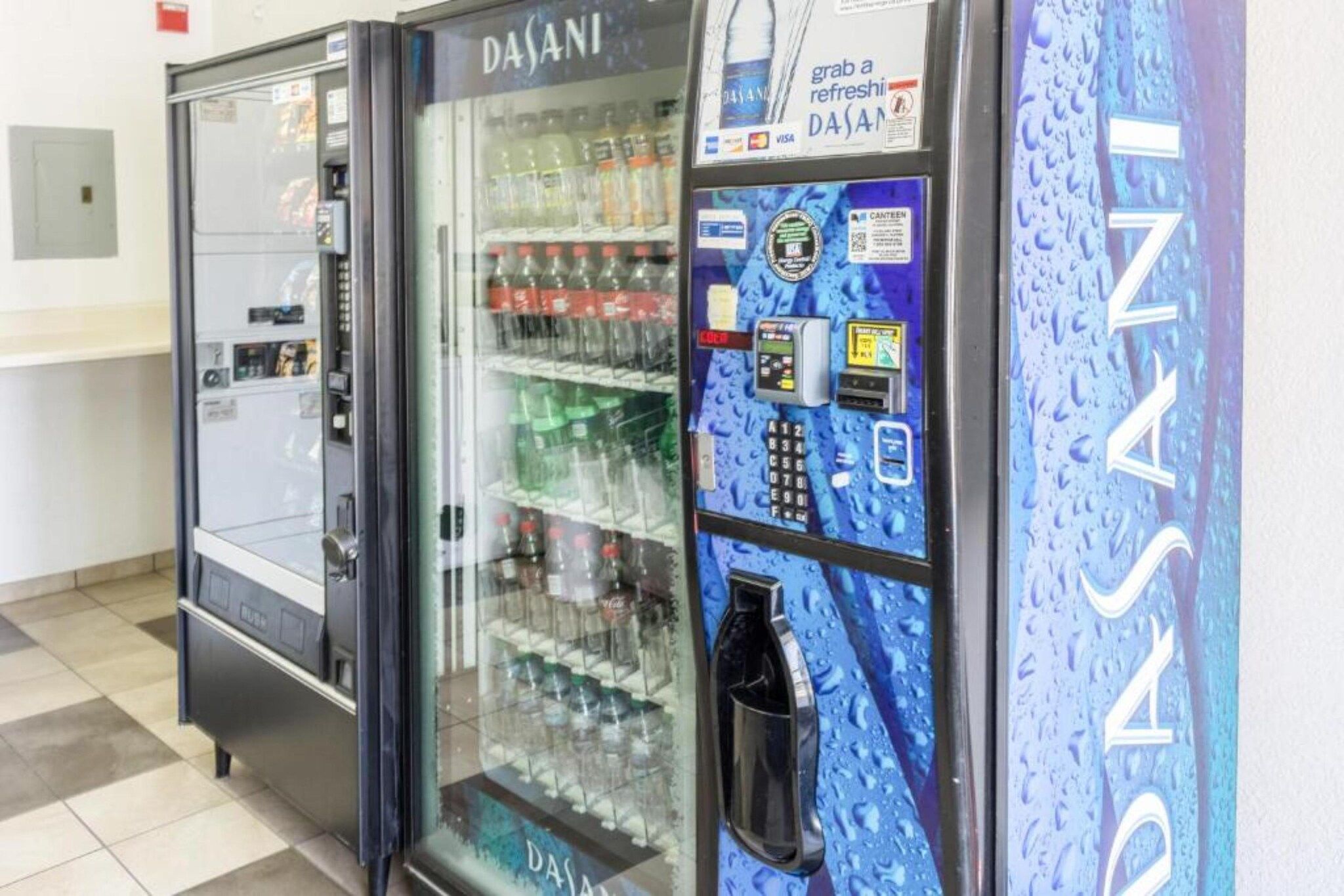 A vending machine with a water dispenser and a beverage cooler.