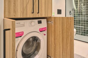 A front-loading washing machine with a control panel and a label indicating a 30-minute program. - Tal, 2BR, Premium, Brand New (Kadıköy)