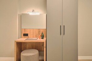A small, modern room with a wooden desk, a laptop, a bottle, and a lamp. - Tal, 2BR, Premium, Brand New (Kadıköy)