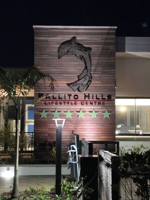 A building with a sign for 'Ballito Hills Lifestyle Centre' featuring a dolphin graphic and five stars. - Your Private Coastal Escape in Ballito, Dolphin Coast Bliss (Dolphin Coast)