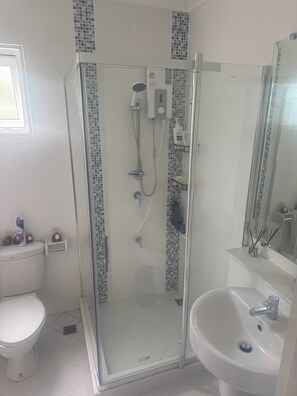 A modern bathroom with a glass-enclosed shower, a toilet, and a sink. - The Oasis Pool Villa (Chiang Mai)