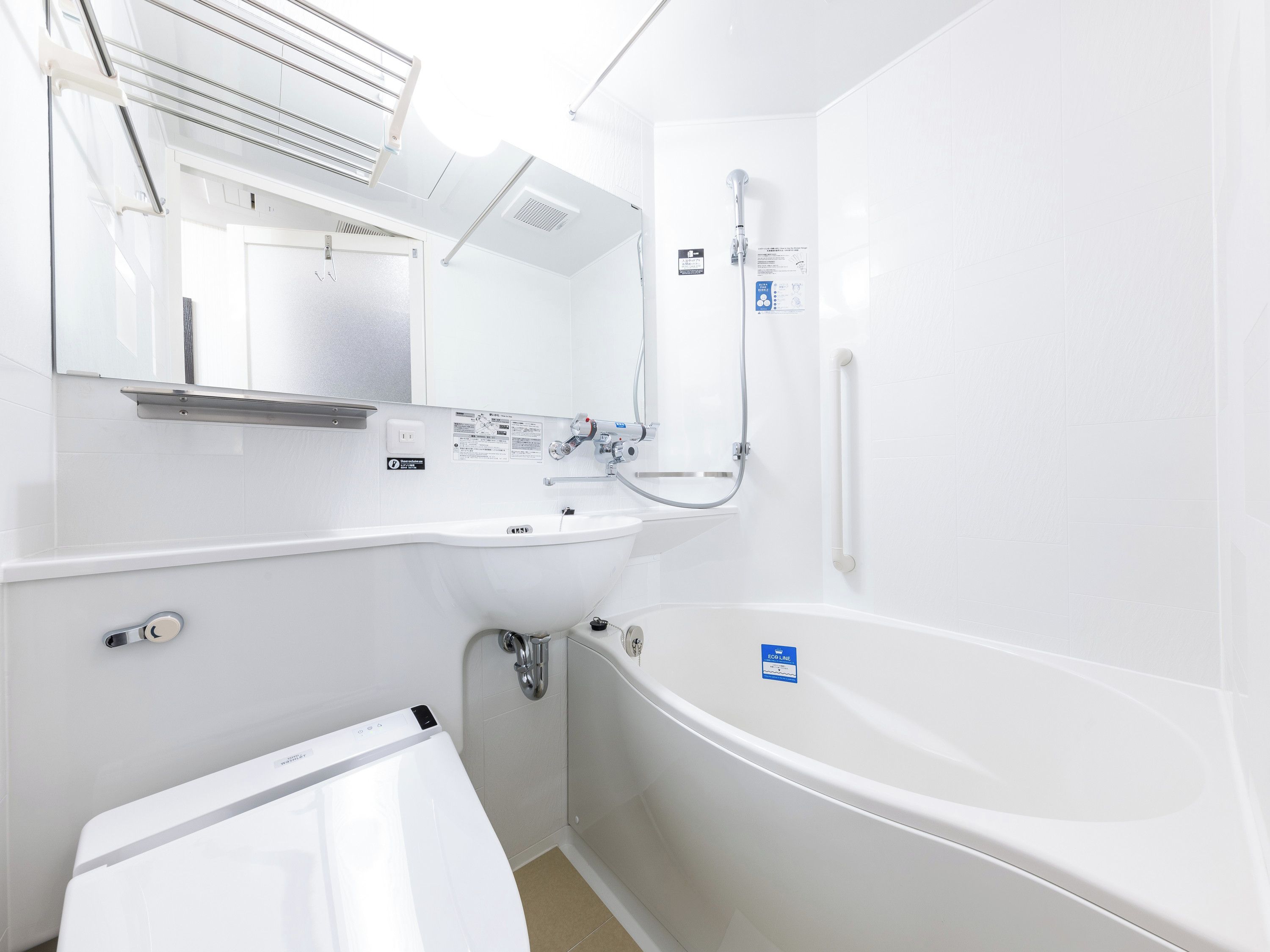 A modern bathroom with a bathtub, a sink, and a shower.