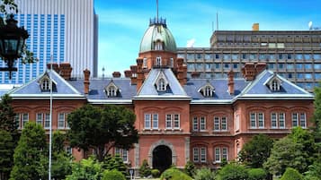 A historic building with a central dome, symmetrical windows, and a formal entrance.