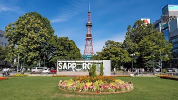 A park with a prominent tower and a sign reading 'SAPPORO'.