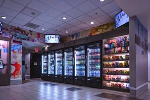 A vending area with multiple beverage dispensers and snack shelves. - 2  Full Beds|ADA/Tub (Inglewood)