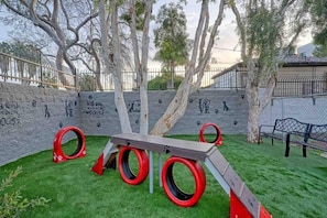 An outdoor play area with a slide, tire swings, and a wooden bench. - 2 Queen Beds|Premium| Mini Fridge (Inglewood)