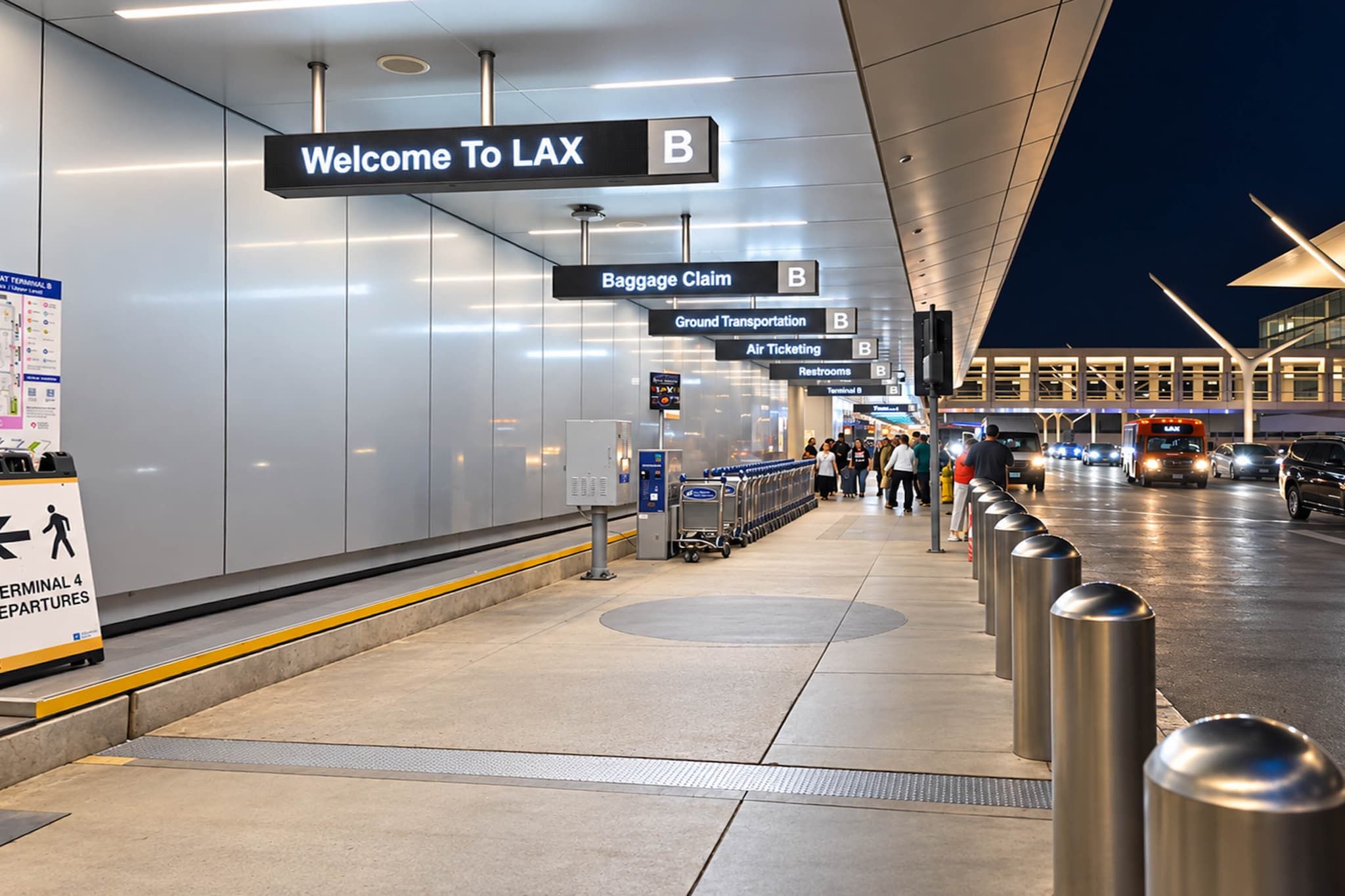 An airport terminal with clear signage for baggage claim, air ticketing, and restrooms.