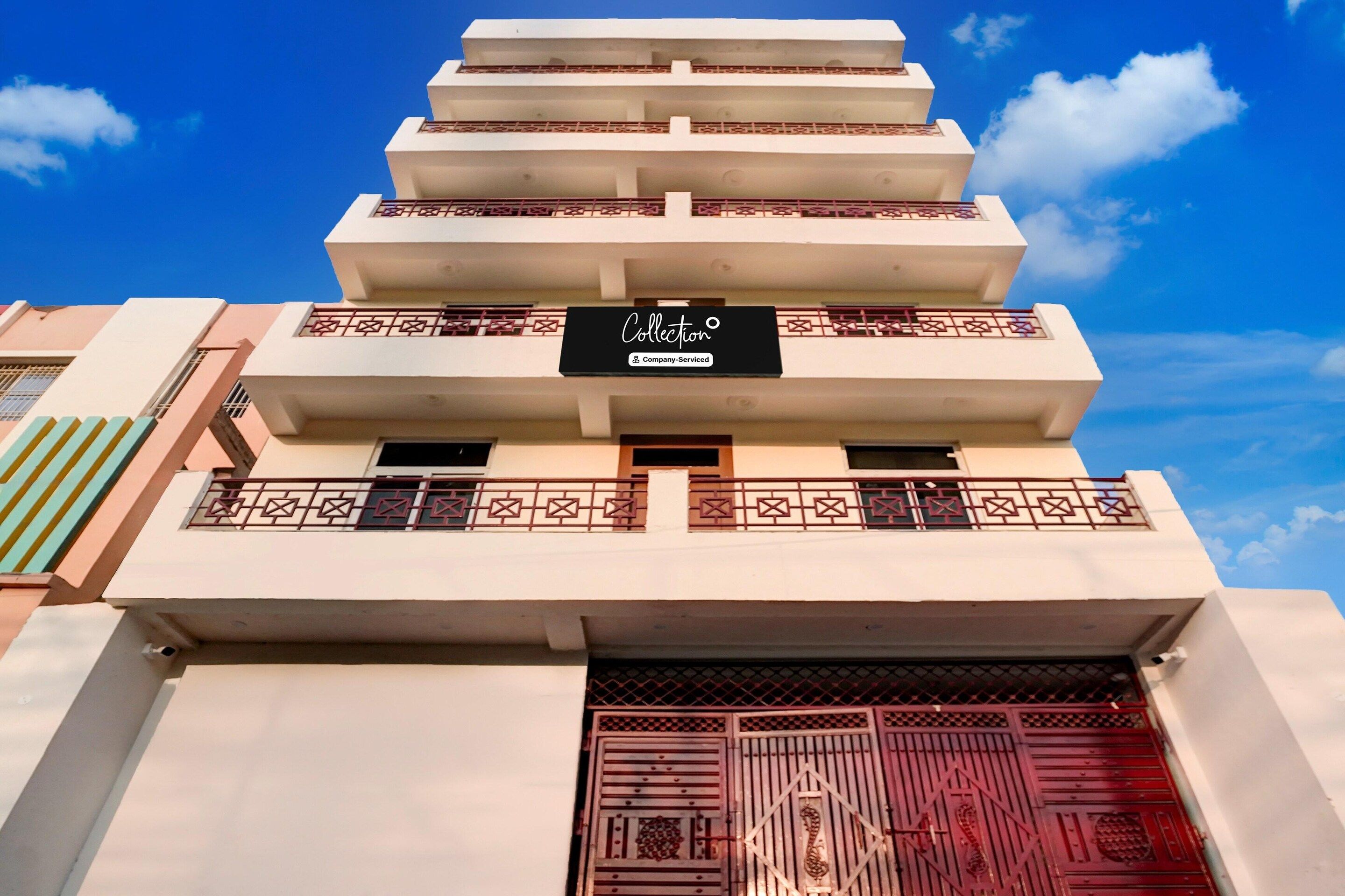 A multi-story building with a sign indicating 'Collection Company-Serviced'.