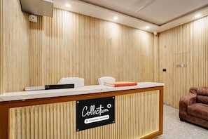 A reception desk with a sign indicating 'Collection' and 'Company-Serviced.' - Deluxe Hotel Chandrashila Residency (Patna)