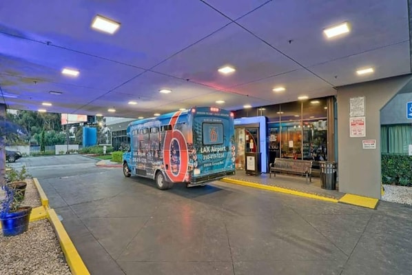 A bus parked at a terminal with a sign indicating it's for LAX Airport. - 1 King Bed|Mini Fridge (Inglewood)