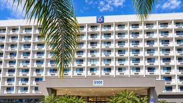 A multi-story hotel with a prominent '6' sign, indicating it is part of a hotel chain. The address '5101 West Century Blvd' is visible above the entrance.