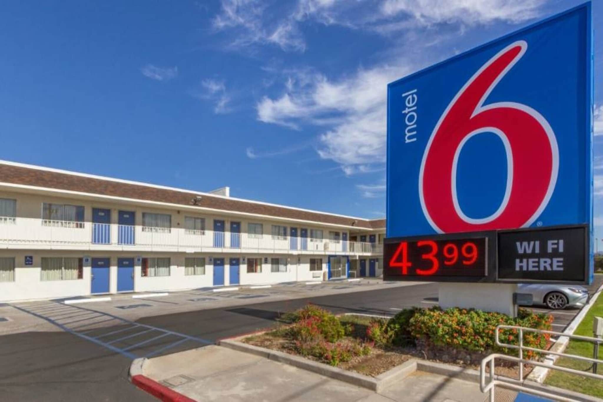 A motel with a large sign displaying the number 6 and a price of $43.99.