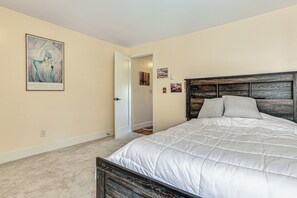 A bedroom with a bed, a door, and a painting on the wall. - 1 Block to Private Key Entry Beach (Bellingham)