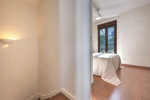 A bedroom with a bed, a window, and a ceiling light. - Marbella gateway - 2BR House /w AC, Patio and Pool Surrounded by Golf Courses (Marbella)