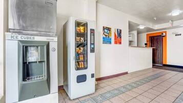 A hallway with an ice dispenser and a vending machine.