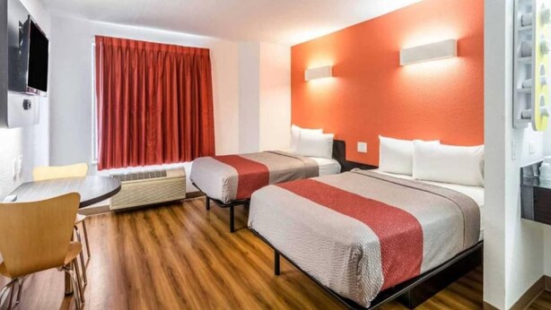 A hotel room with two beds, a desk, and a chair. - 2 Full Beds | Non-Smoking (Harvey)