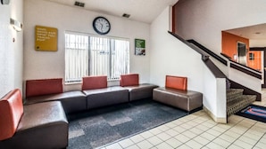A lobby with a seating area, a clock, and a staircase. - 2 Full Beds | Non-Smoking (Harvey)