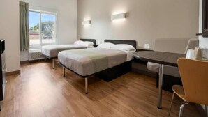A hotel room with two beds, a dining table, and a chair. - 2 Queen Beds|Hearing Accessible,Kitchen (Corpus Christi TX)