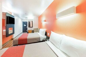 A hotel room with two beds, a TV, a mirror, and a door. - 2 Full Beds|Nsmk,Mini Fridge (Fort Worth)