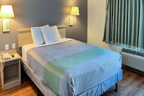 A hotel room with a bed, bedside lamps, a nightstand, a telephone, and a window with curtains. - 1 Queen Bed|Mobil Access|Nsmk|Kitchen (Belmont)
