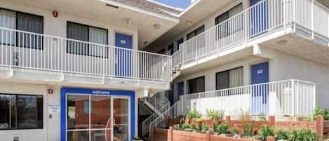 A multi-story building with a ground-level entrance marked 'Welcome.'