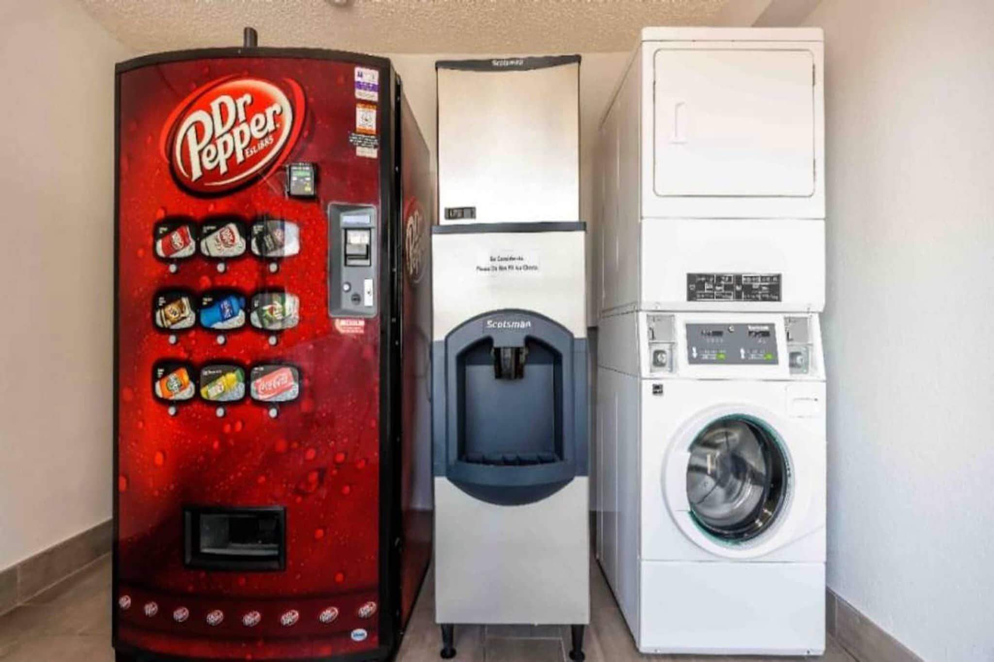 A vending machine, a water dispenser, and a washing machine in a room.