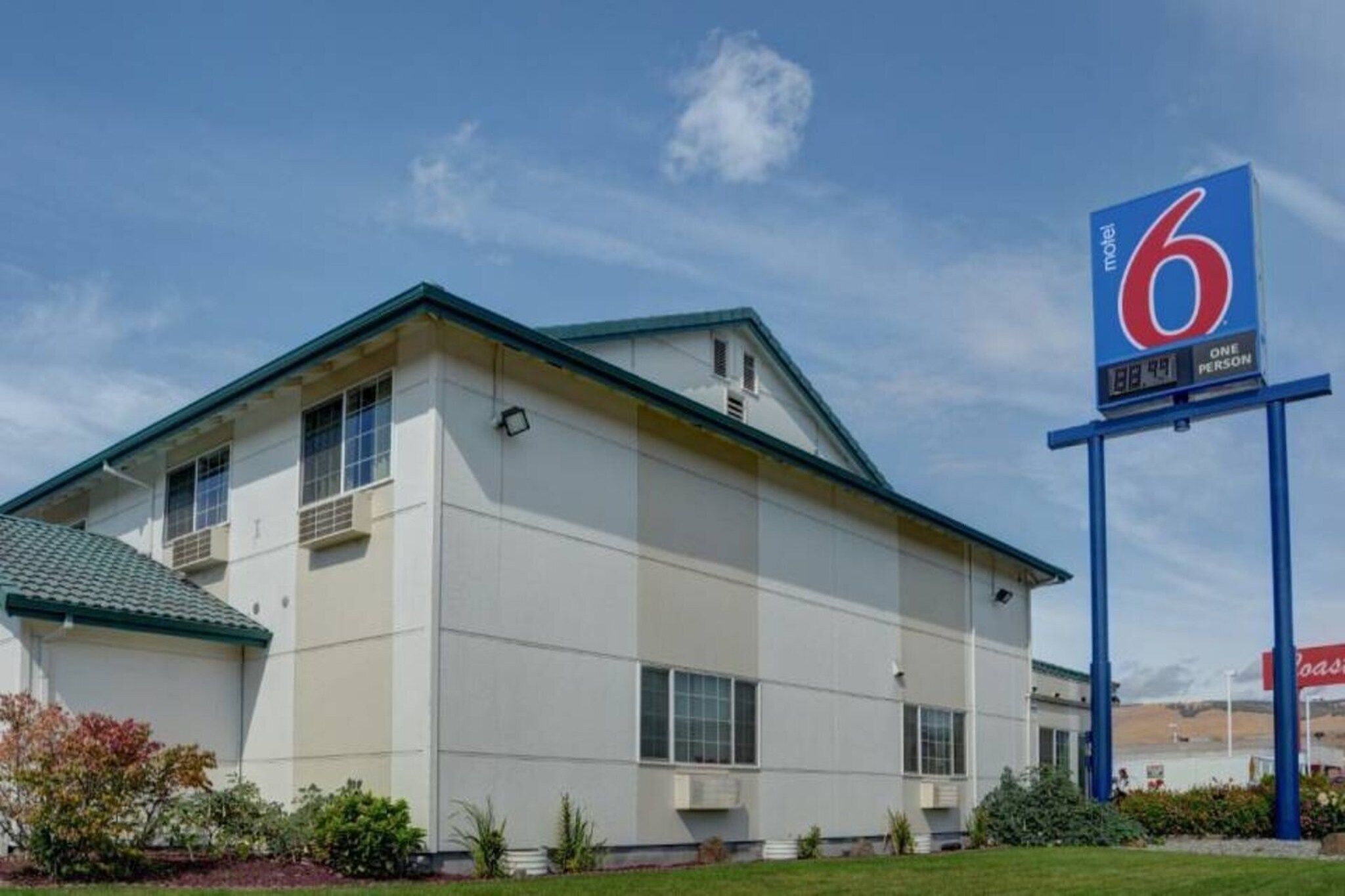 A motel with a large sign indicating it is a 6-person establishment.