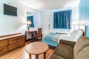 A hotel room with a bed, a desk, a chair, a dresser, and a television. - 2 Queen Beds | Non-Smoking (Southgate)
