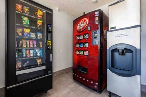 A vending machine with a variety of snacks and a drink dispenser. - 1 Queen Bed | Non-Smoking (Fort Worth TX)