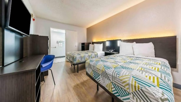 A hotel room with a bed, a desk, a chair, and a television. - 2 Queen Beds | Non-Smoking (Fort Worth TX)
