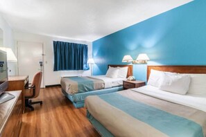 A hotel room with two beds, a desk, a chair, and a window with curtains. - 2 Queen Beds | Non-Smoking (Southgate)