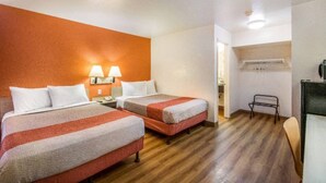 A hotel room with two beds, a desk, and a chair. - 2 Full Beds | Youngtown (Youngtown)