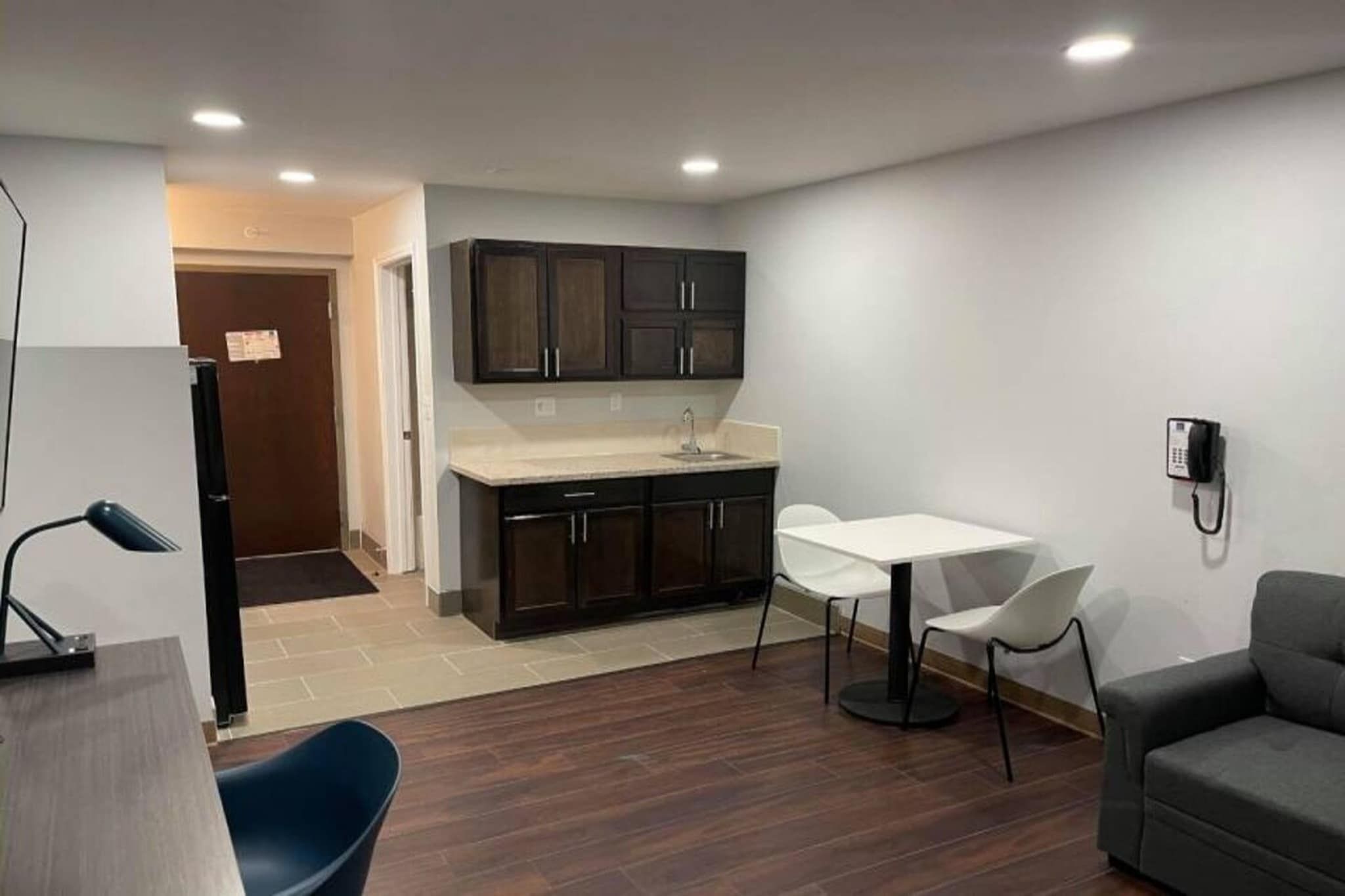 A compact living space with a kitchenette, a dining area, and a seating area.