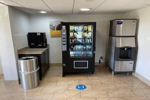 A vending machine, a trash bin, and a water dispenser in a commercial setting. - 1 Queen Bed| Nsmk Kitchen, Sofa-Bed (Peoria IL)