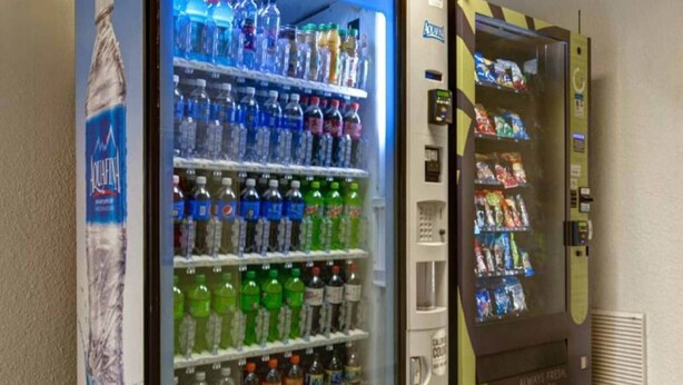 A vending machine with a variety of beverages and snacks. - 2 Full Beds | Non-Smoking, Kitchen (Jacksonville)