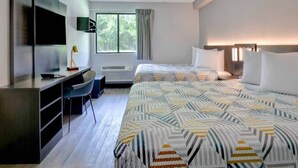 A hotel room with a bed, desk, chair, TV, and a window with curtains. - 2 Full Beds | Non-Smoking, Kitchen (Jacksonville)
