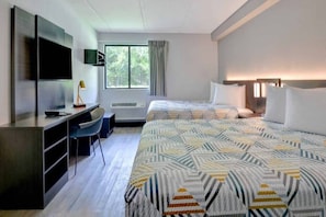 A hotel room with a bed, desk, chair, TV, and a window with curtains. - 2 Full Beds | Non-Smoking, Kitchen (Jacksonville)
