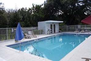A swimming pool with a lifeguard station, lounge chairs, and a fenced area. - 1 Queen Bed|Micfridge,Smoking (Kissimmee)